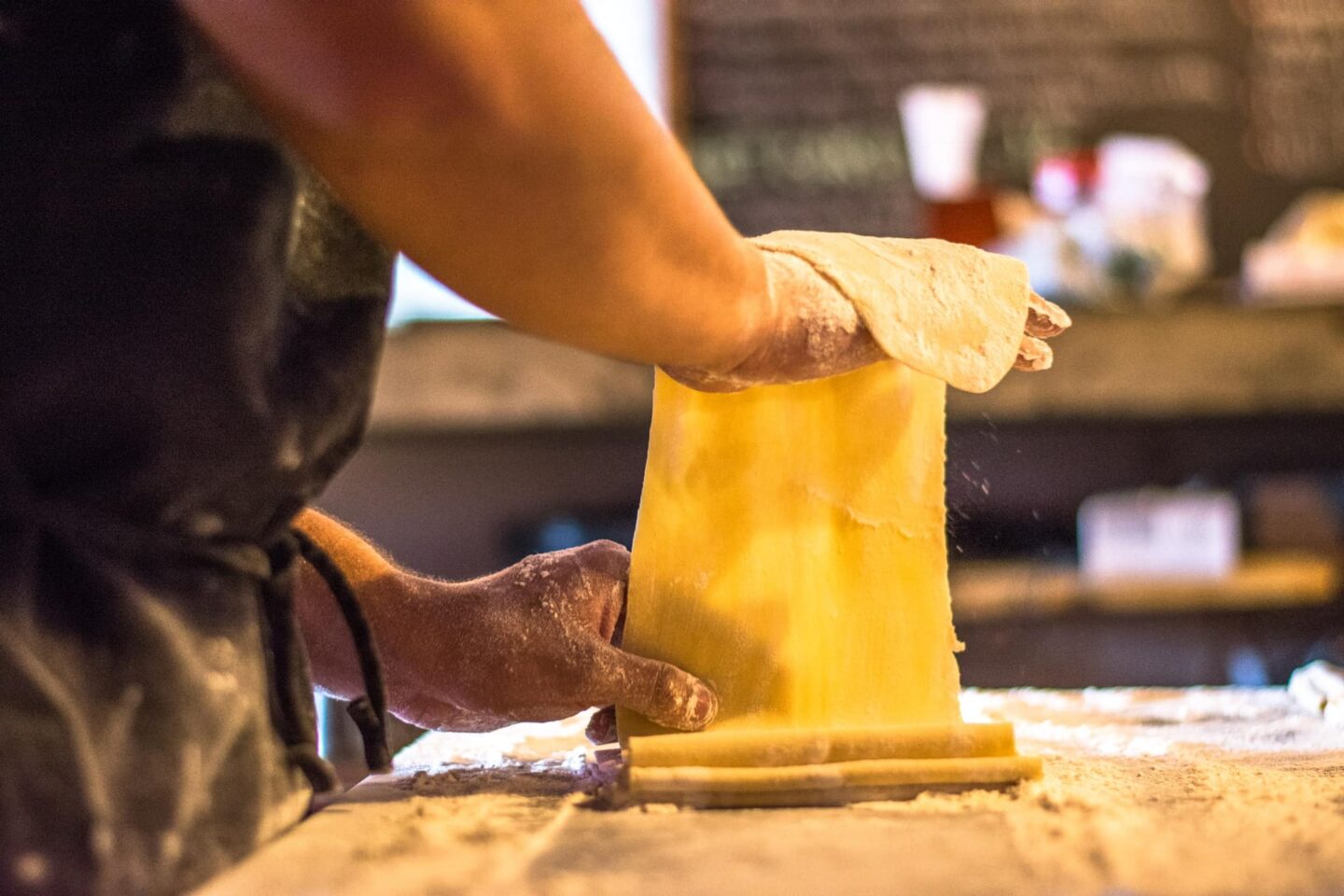 Hands rolling out fresh pasta at Mangia Mi in Calistoga, CA