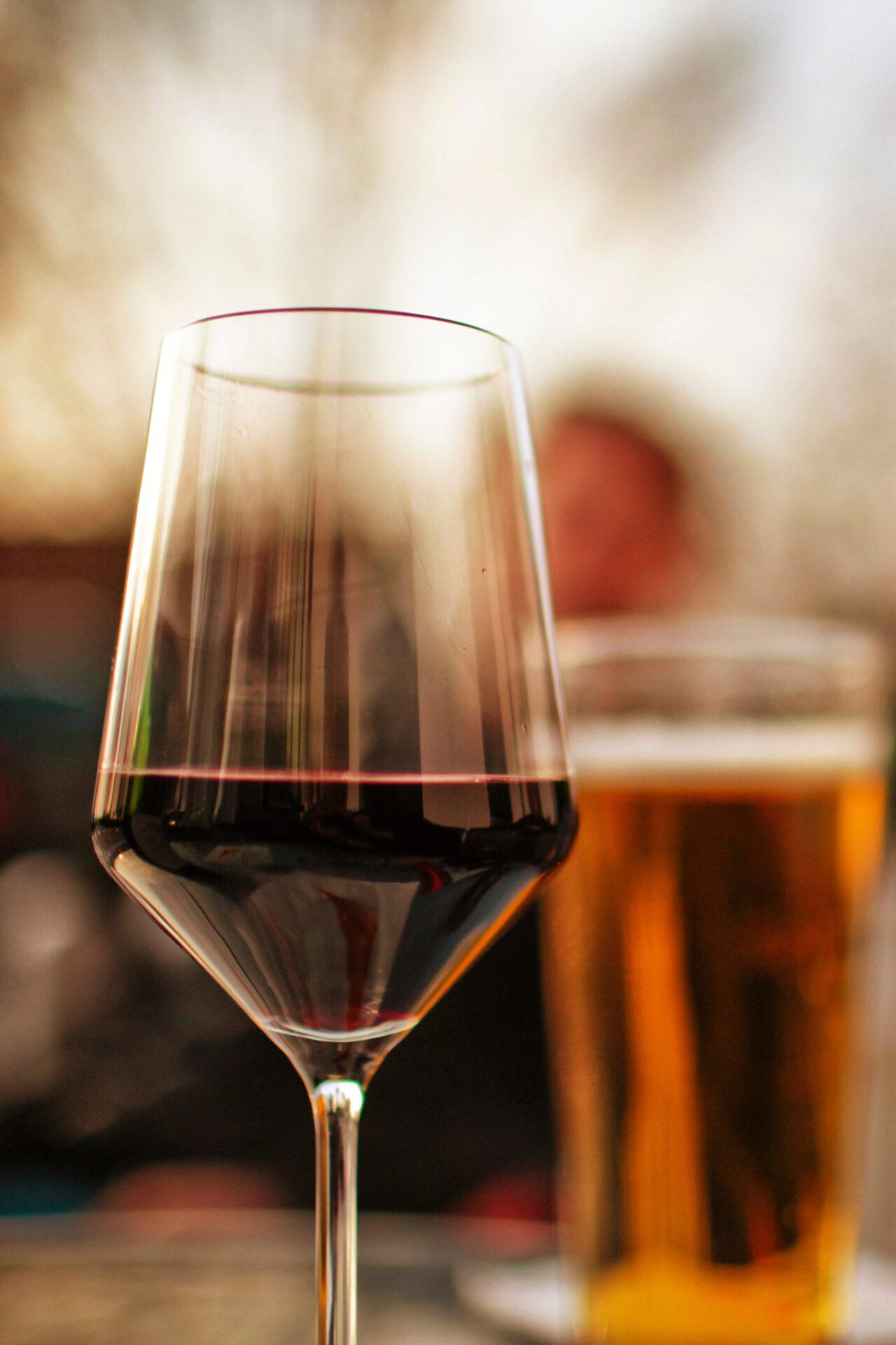 Glass of best wine with chili shown in front of a glass of beer