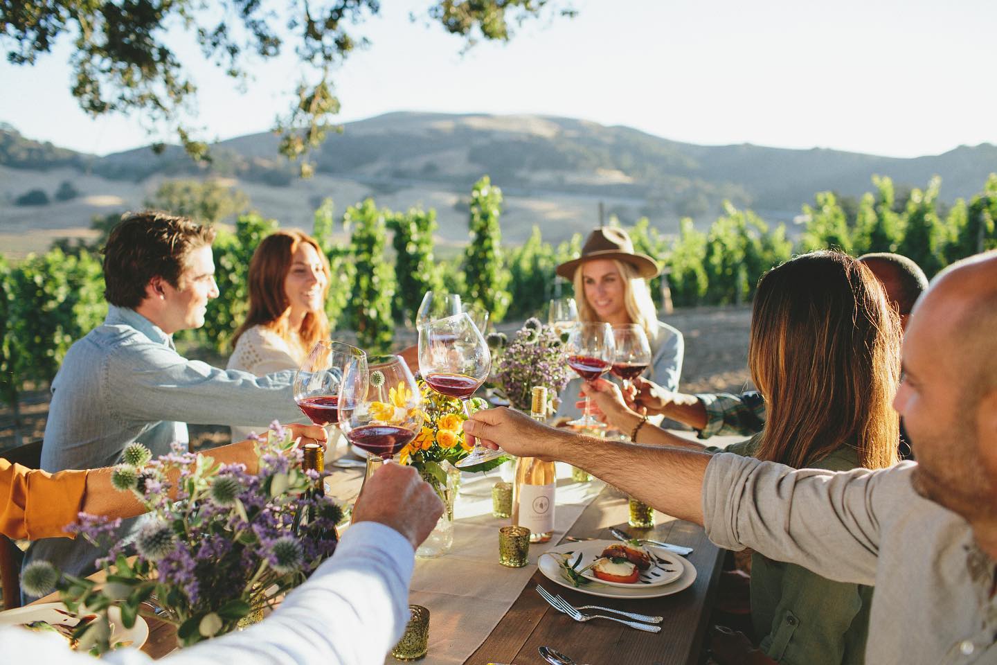 People clinking wine glasses at Folded Hills in Santa Barbara County, CA