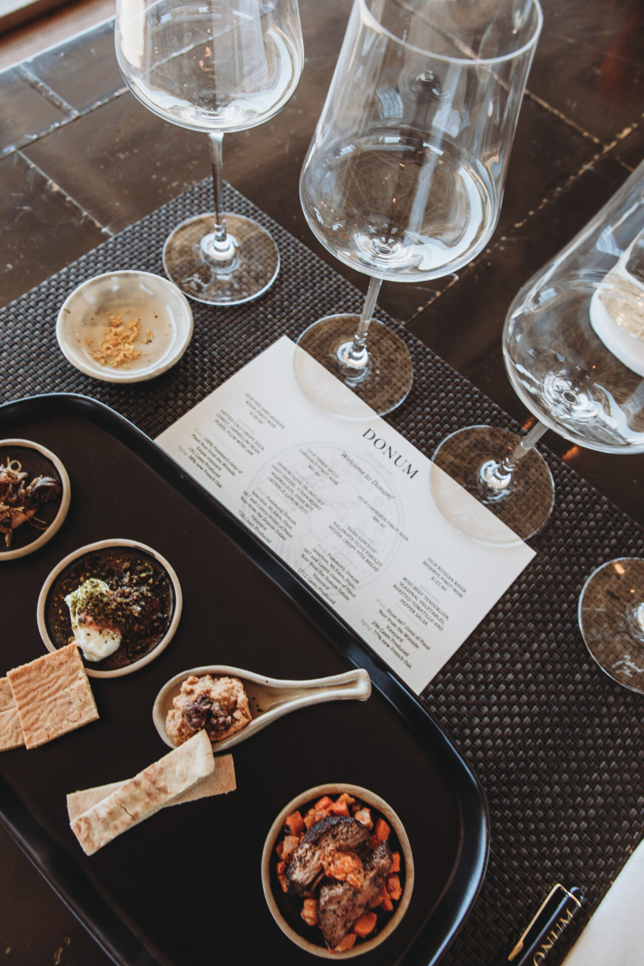 Wine tasting glasses accompanied by small bites