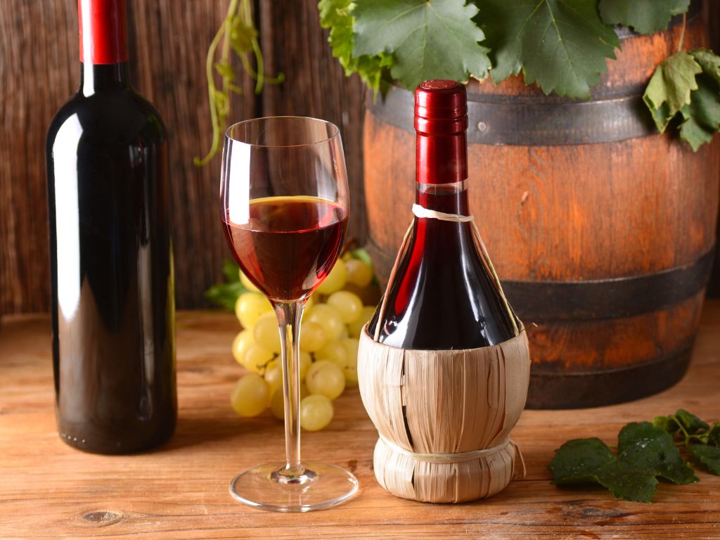 Classic Italian red wine shown in a Chianti holder