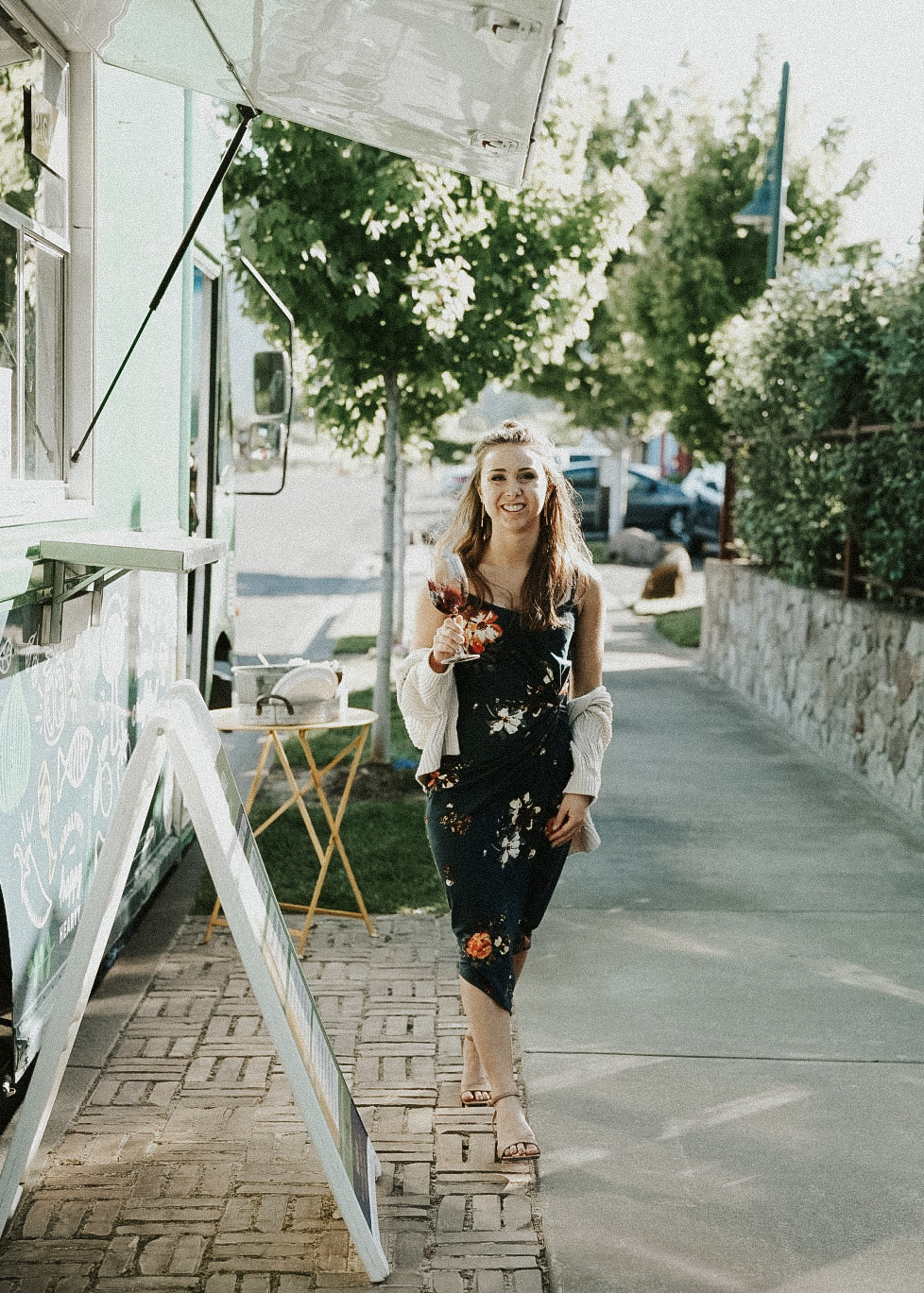 Paige next to the food truck at Clif Family winery holding a glass of wine