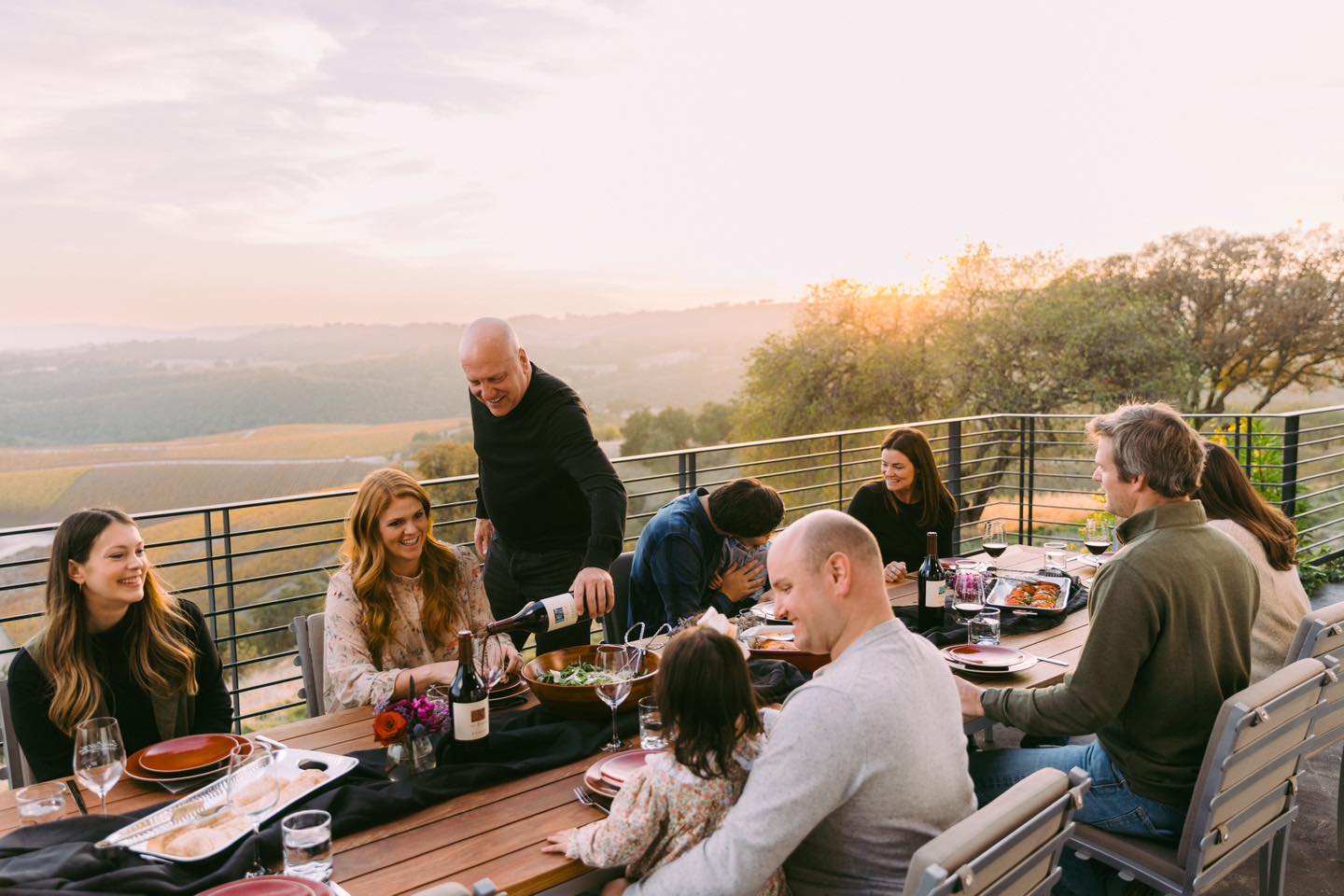 A group of family and friends enjoying wine on the outdoor patio at Epoch Estate Wines