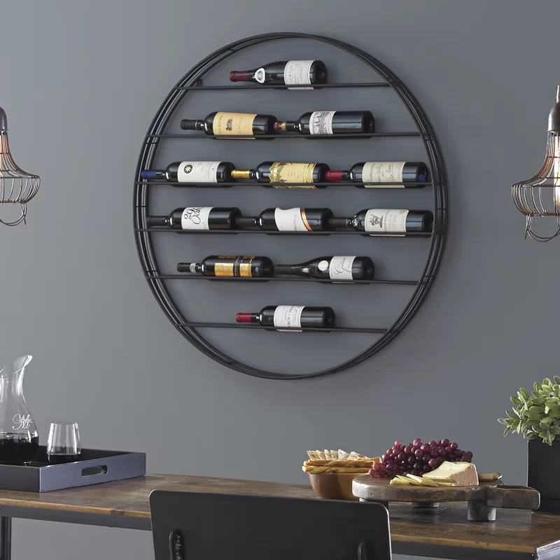 Circular, black wrought iron wine rack mounted to the wall