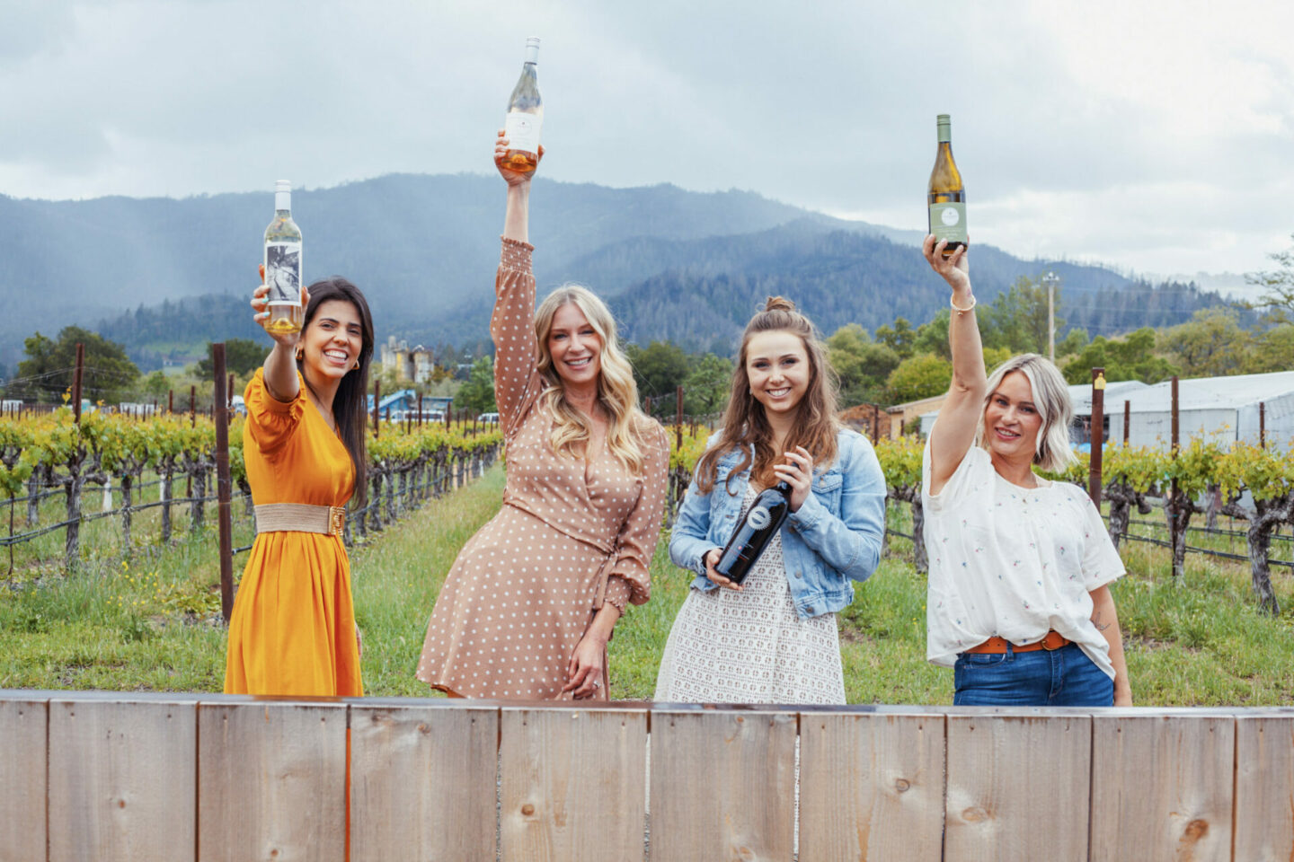 Four women at Clif Family winery holding wine bottles