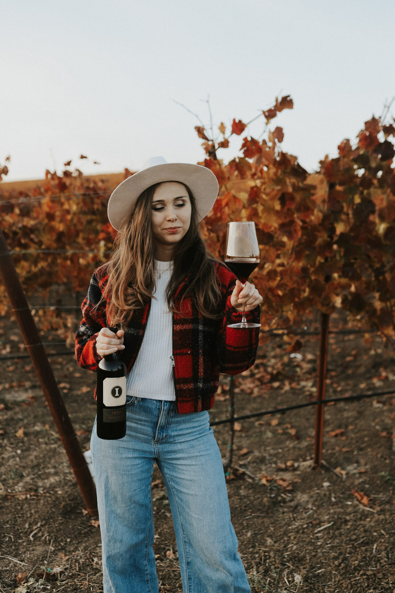 Healthiest Wine - Paige in a vineyard drinking the best red wine for health