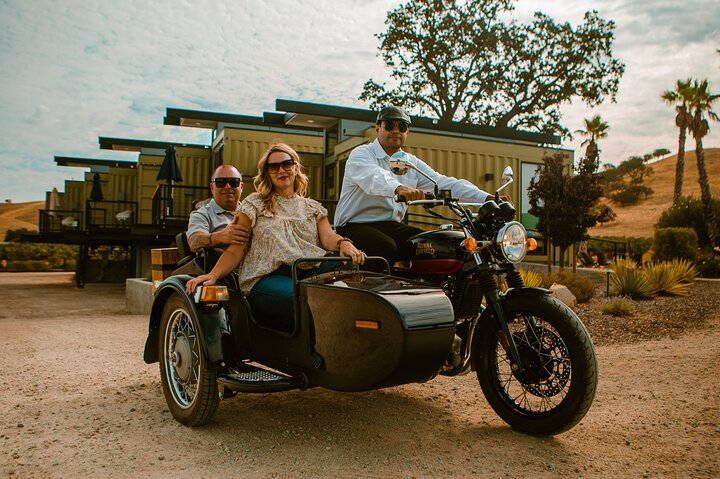 Two people ride in a side car