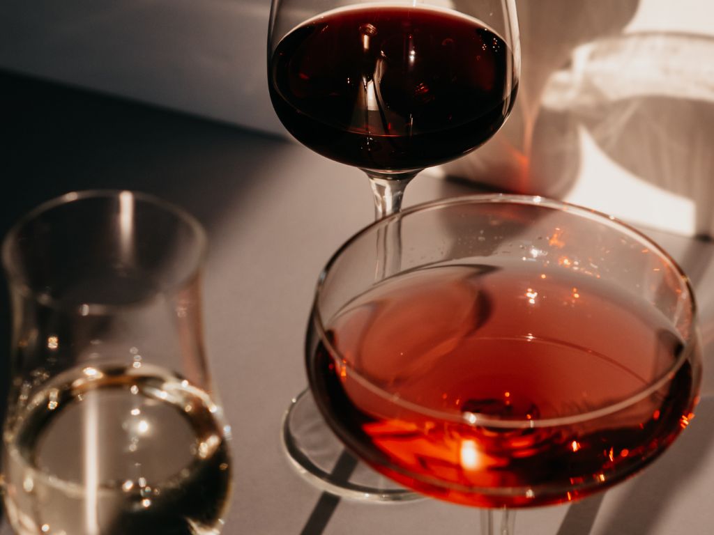Light red wine in a glass in front of a glass of dark red wine