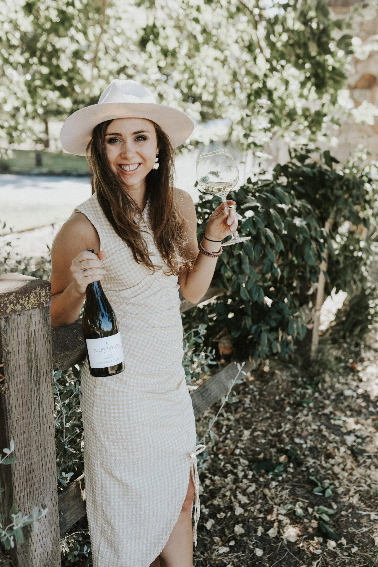 Paige sipping Jules Taylor Sauvignon Blanc on a sunny summer day