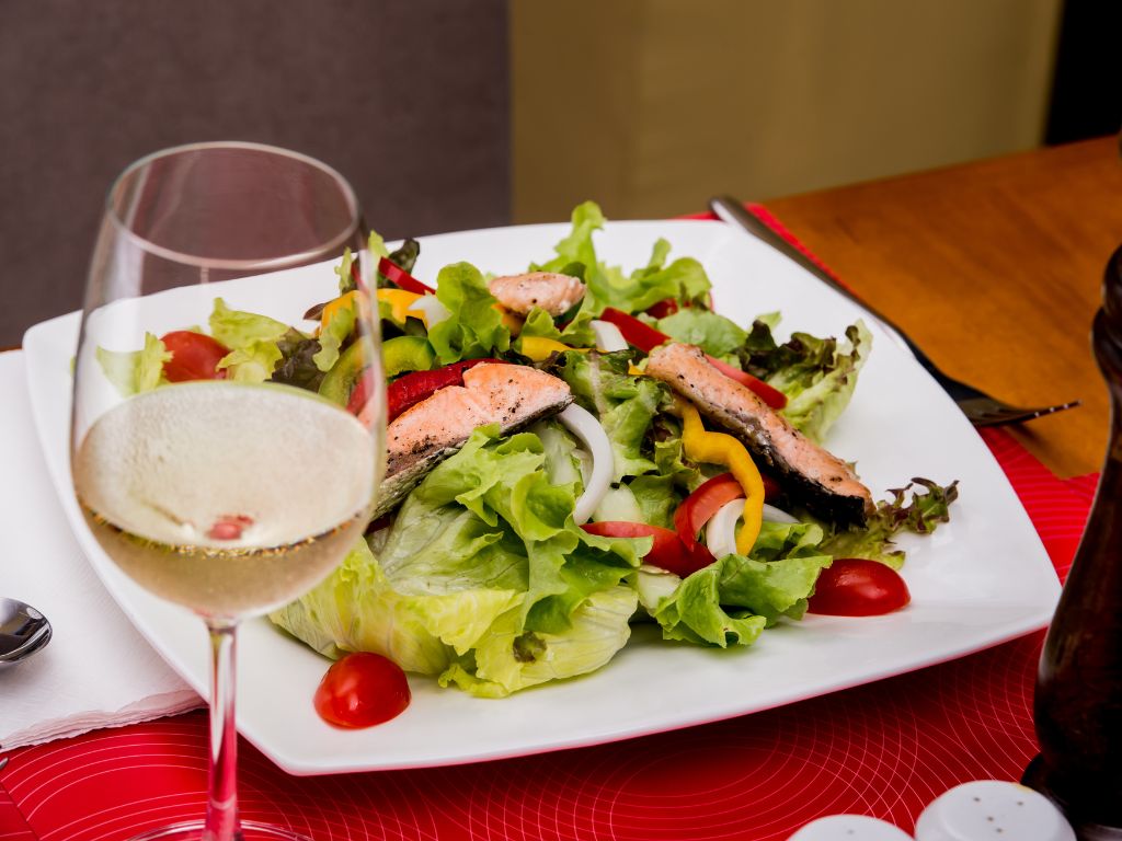 Glass of Pinot Grigio paired with a healthy salad