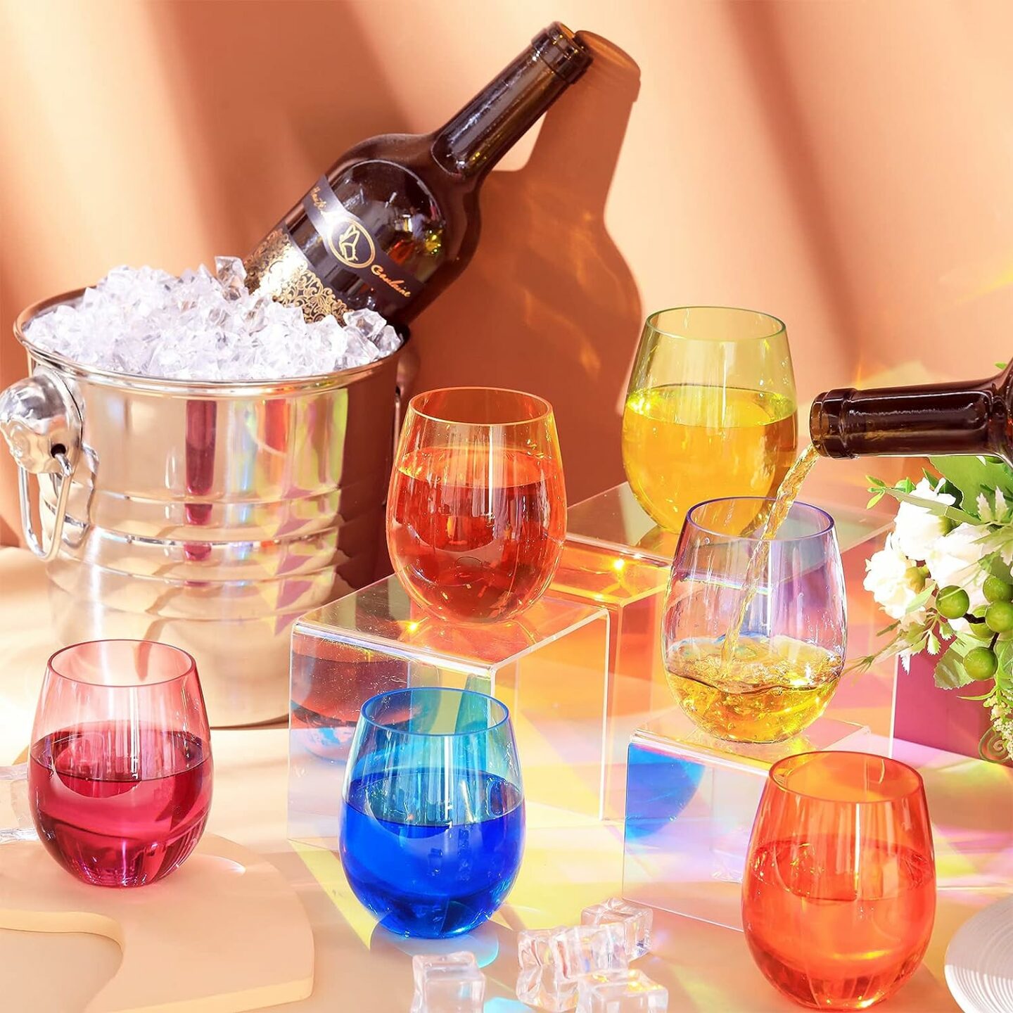 Display of colorful stemless wine glasses on peach tabletop