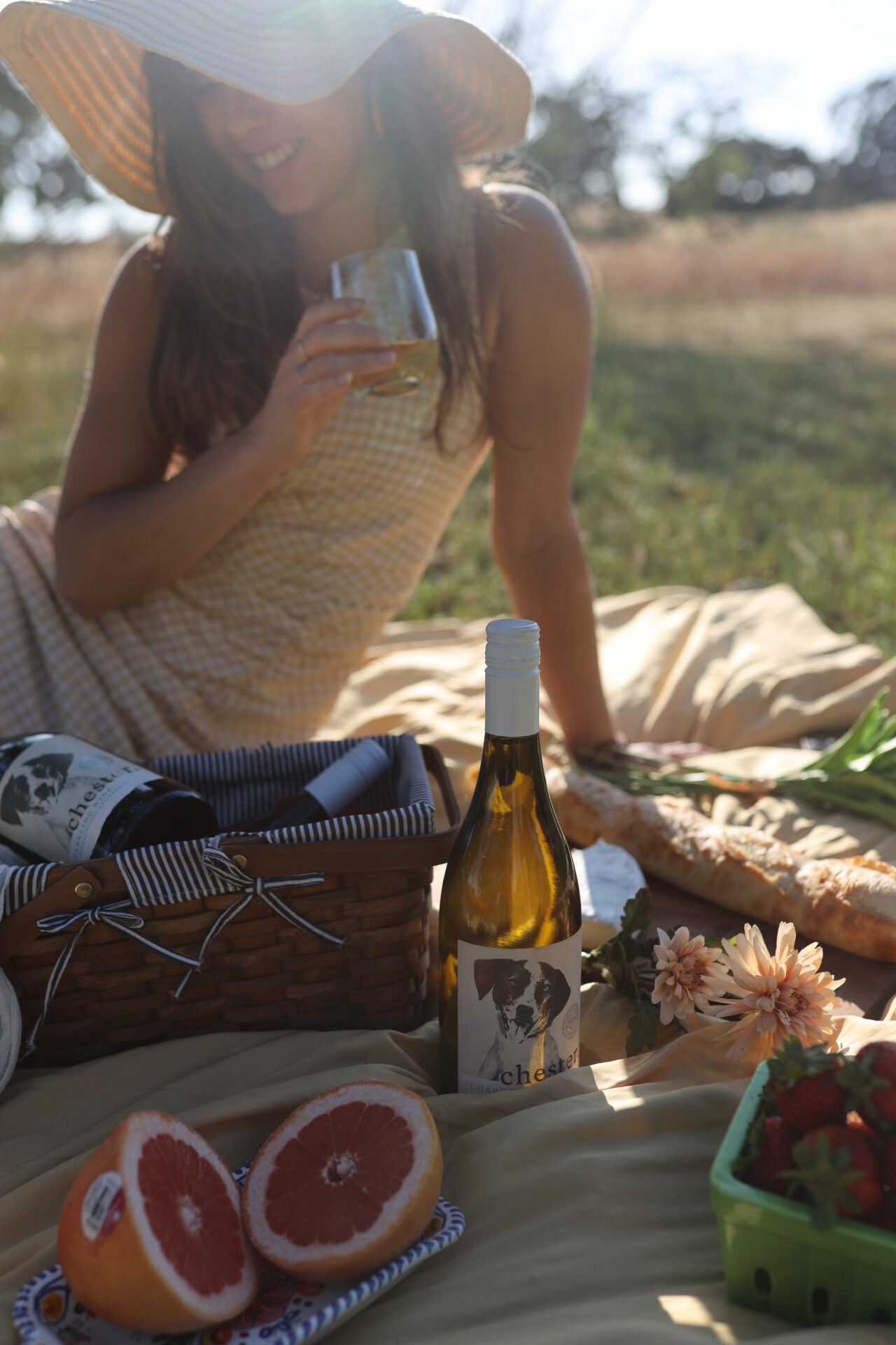 Paige drinking Chester Wine at a picnic