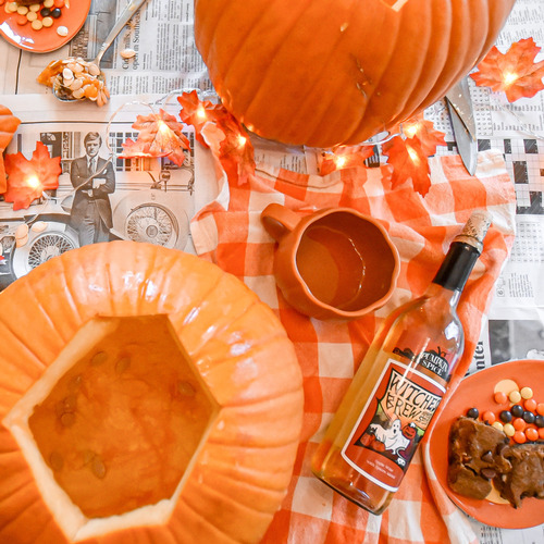 Carved pumpkins and a bottle of pumpkin wine