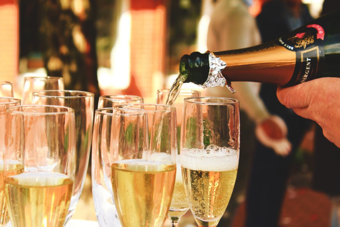 Glasses of champagne being poured at a party