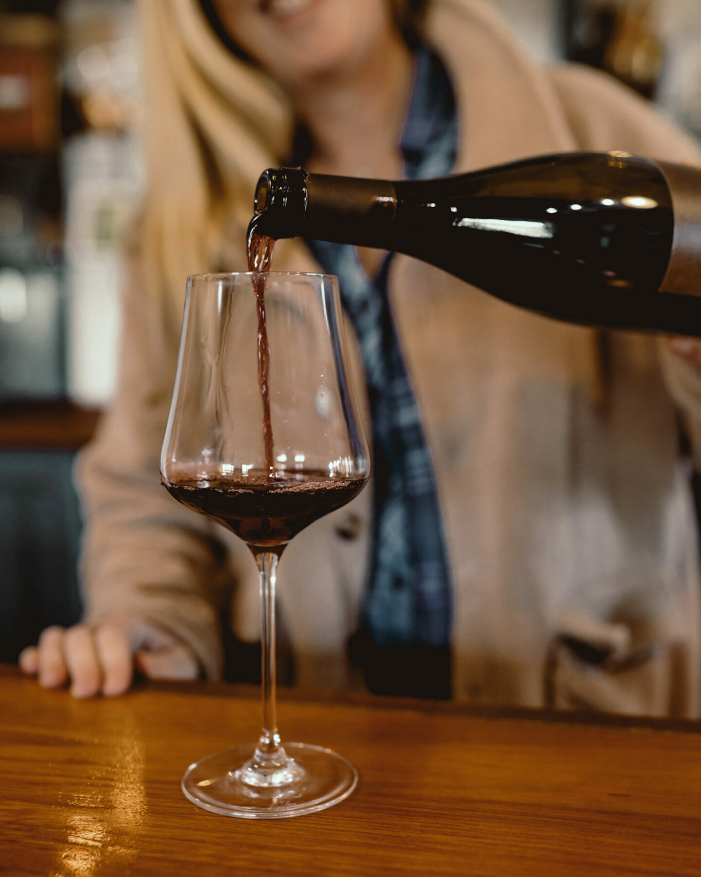 Merlot being poured into a red wine glass