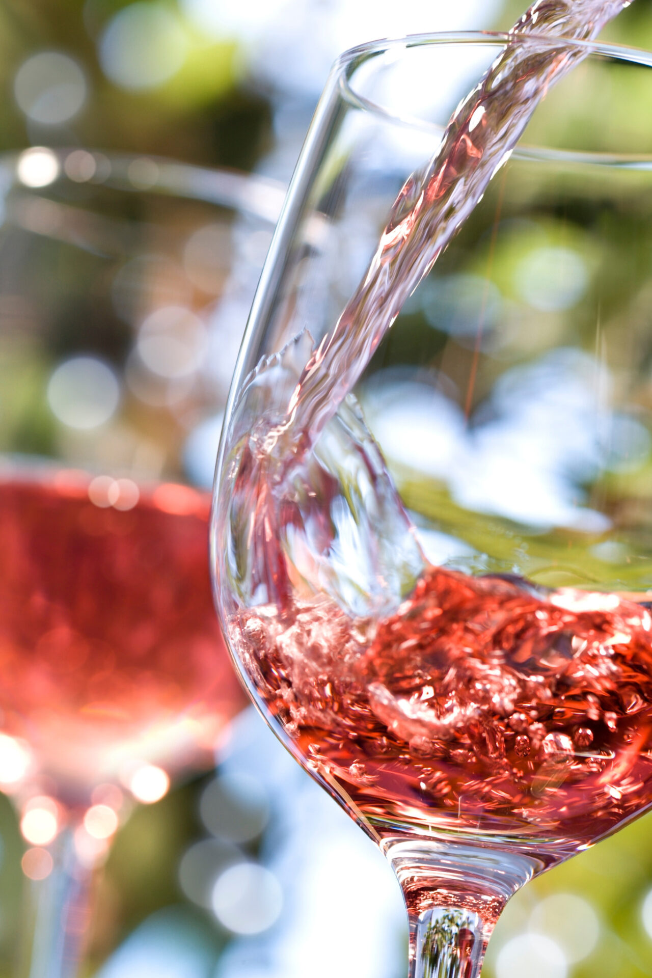 White merlot wine being poured into wine glass