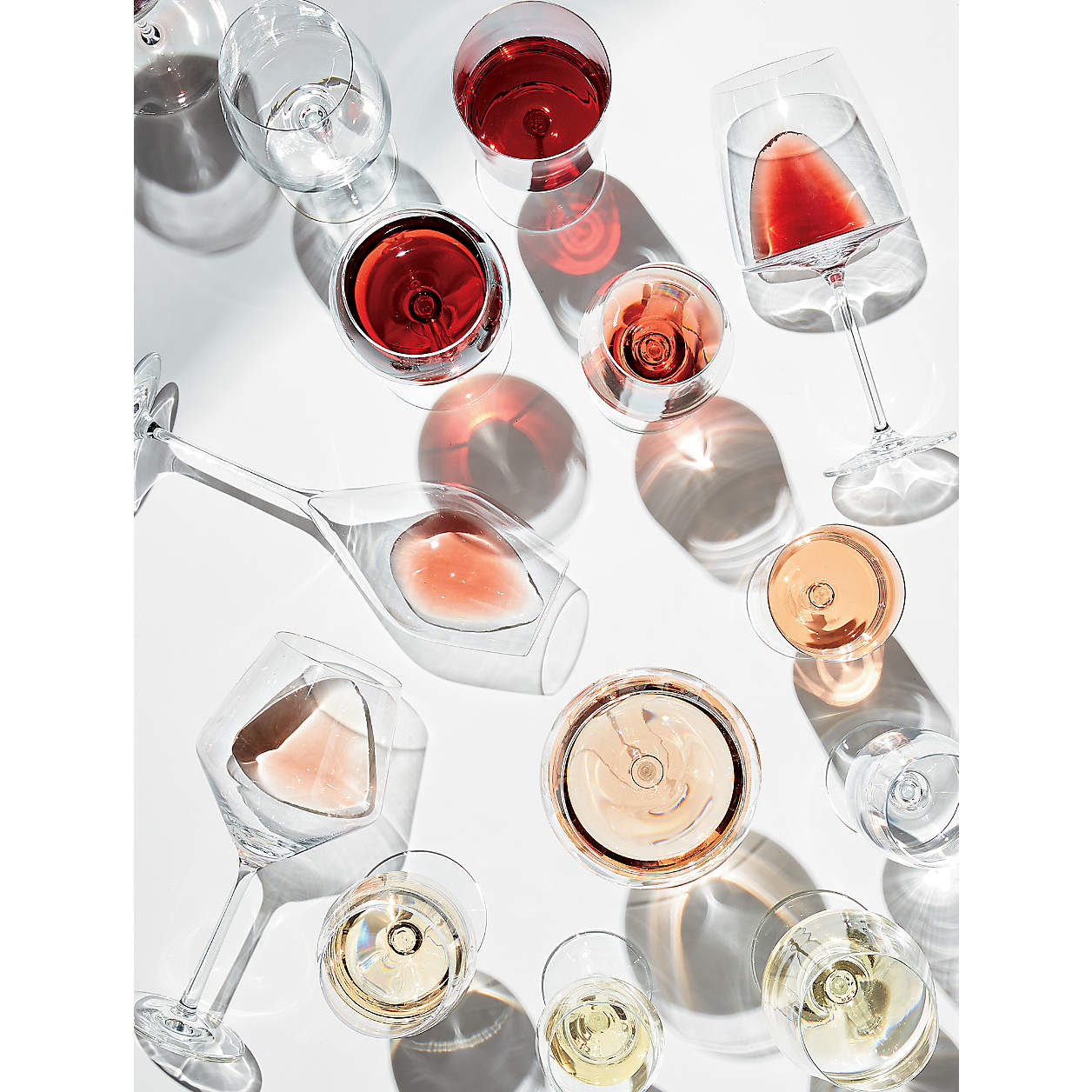 An array of wine glasses from red to white
