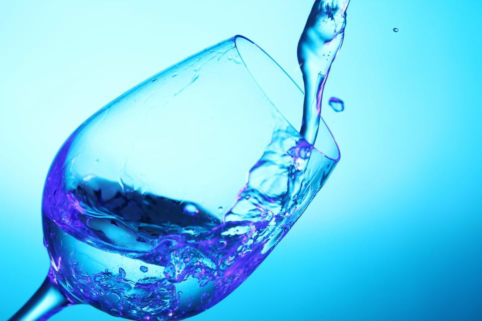Blue wine being poured into blue glass
