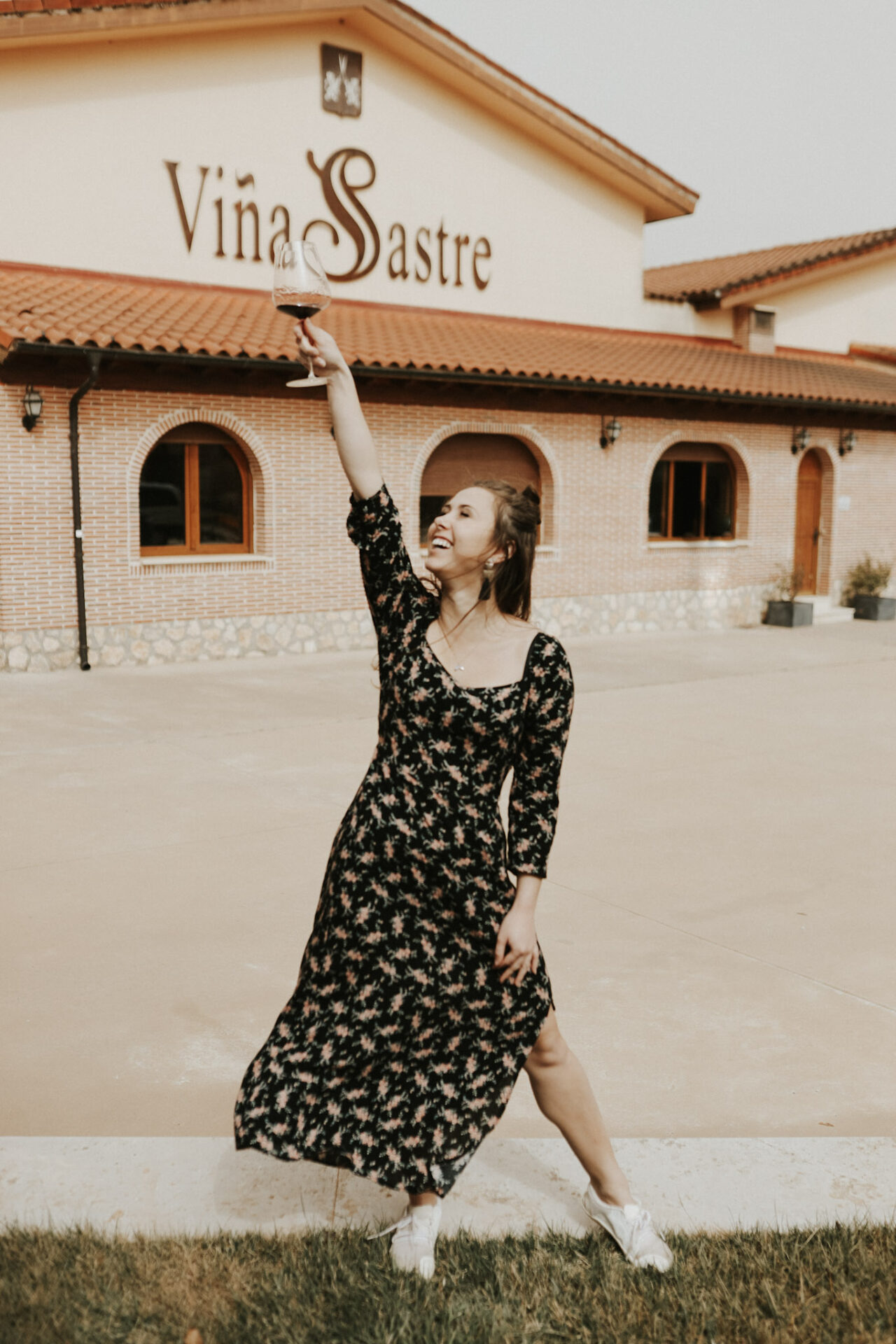 Paige holding a glass of Menicia spanish red wine in Spain