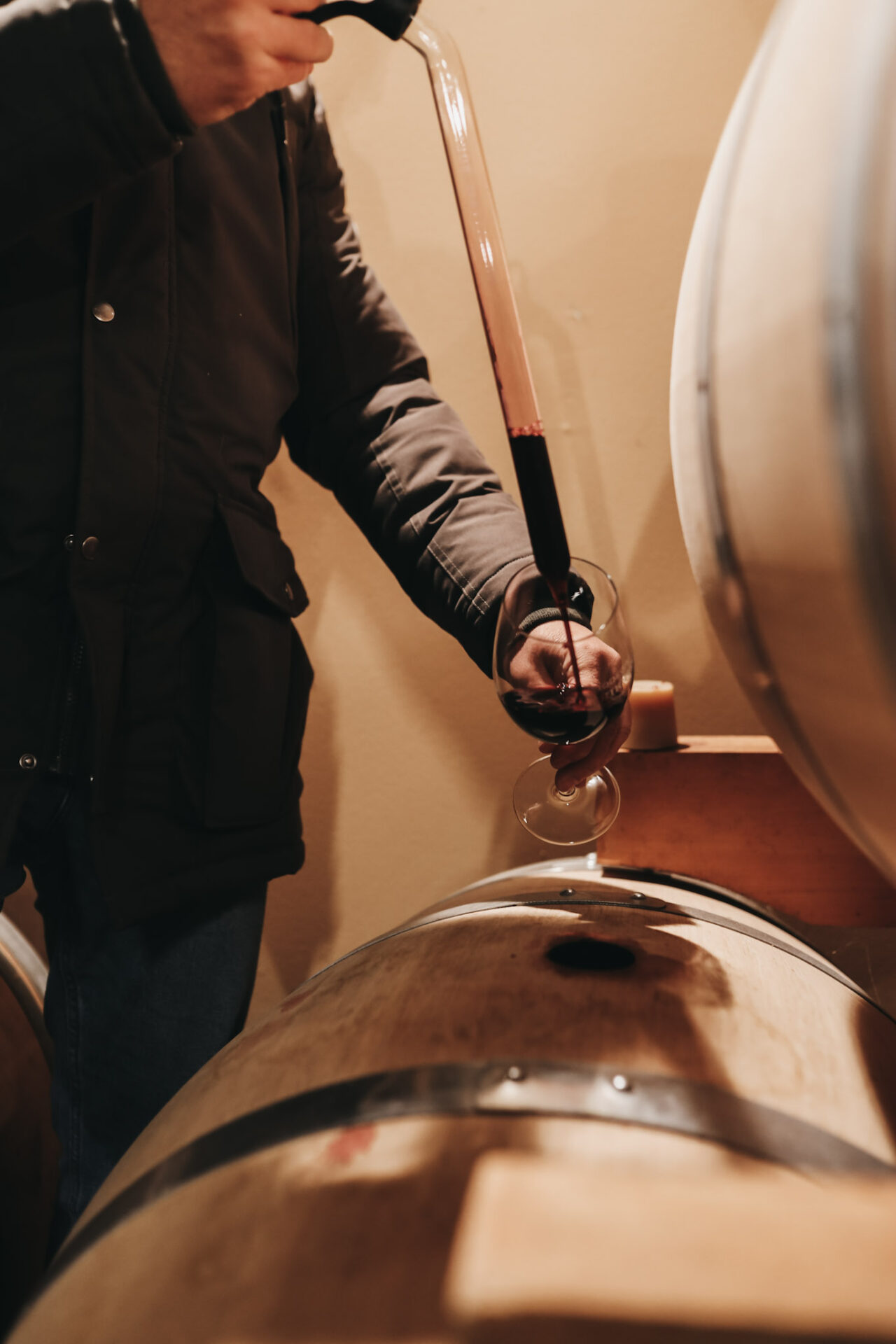 Red wine being pulled from a barrel in Spain