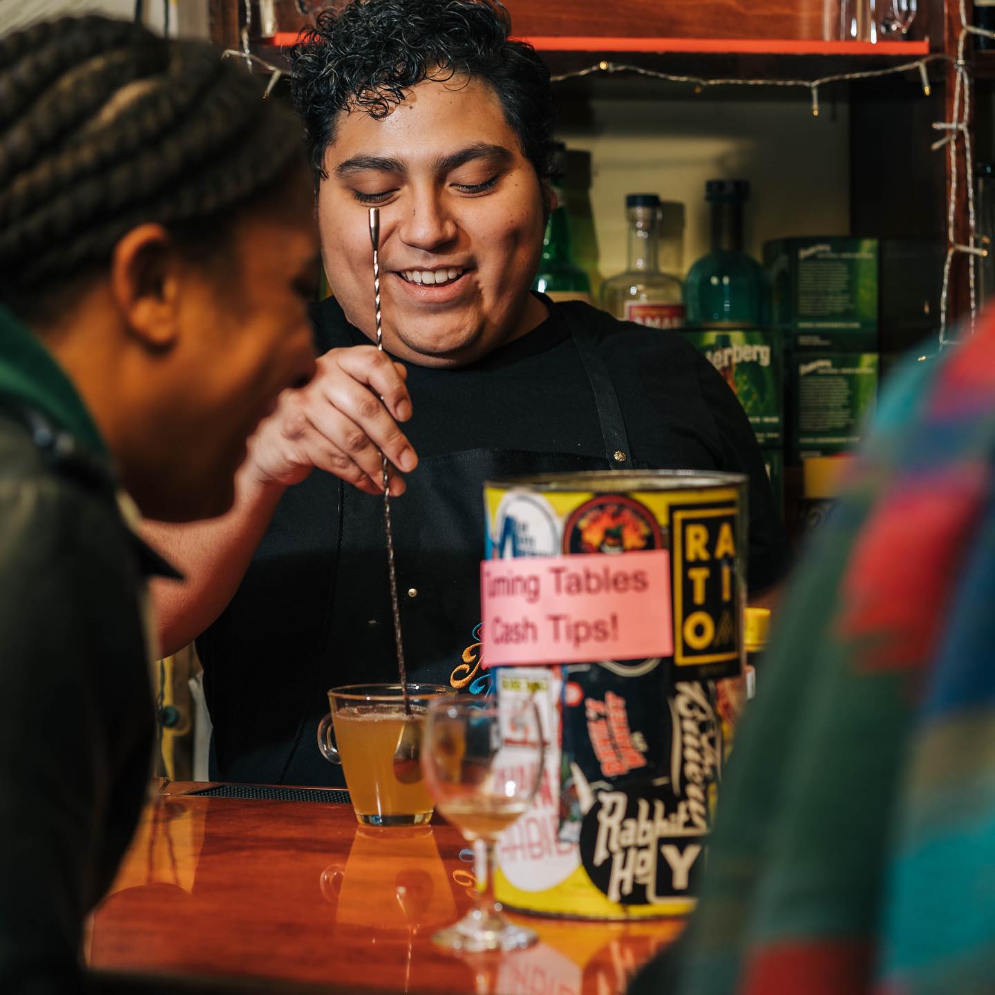 A bar tender mixing drinks at Bacchanal Wine