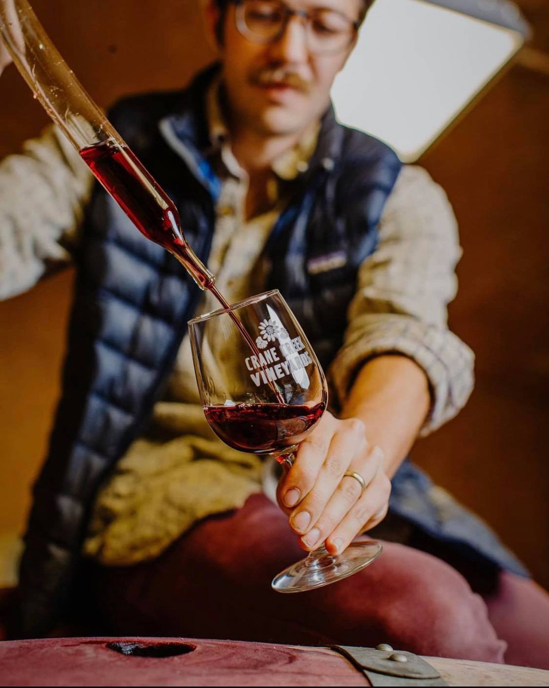 Winemaker pouring a glass of wine for tasting