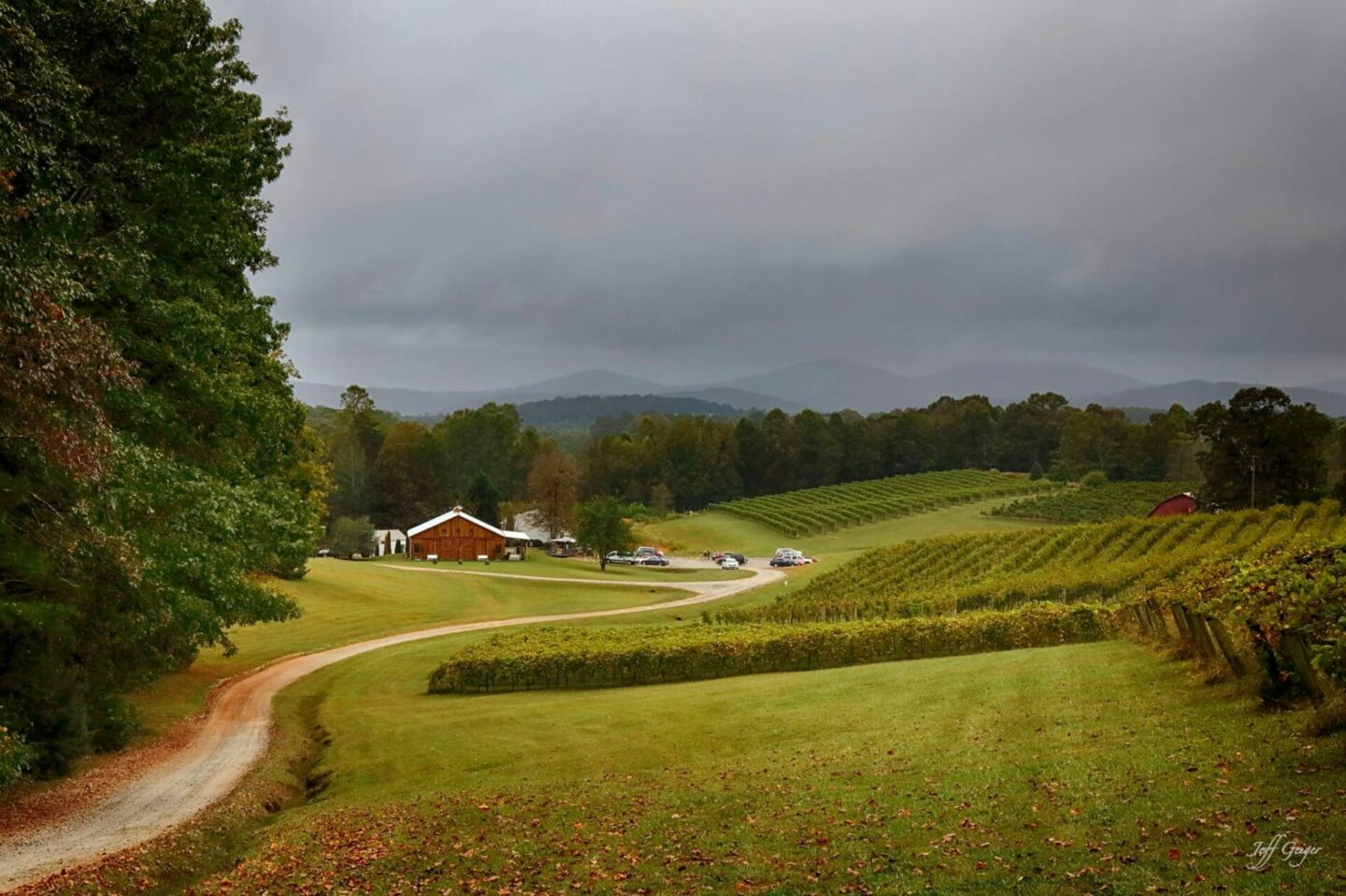 Red barn on a farm with gloomy sky