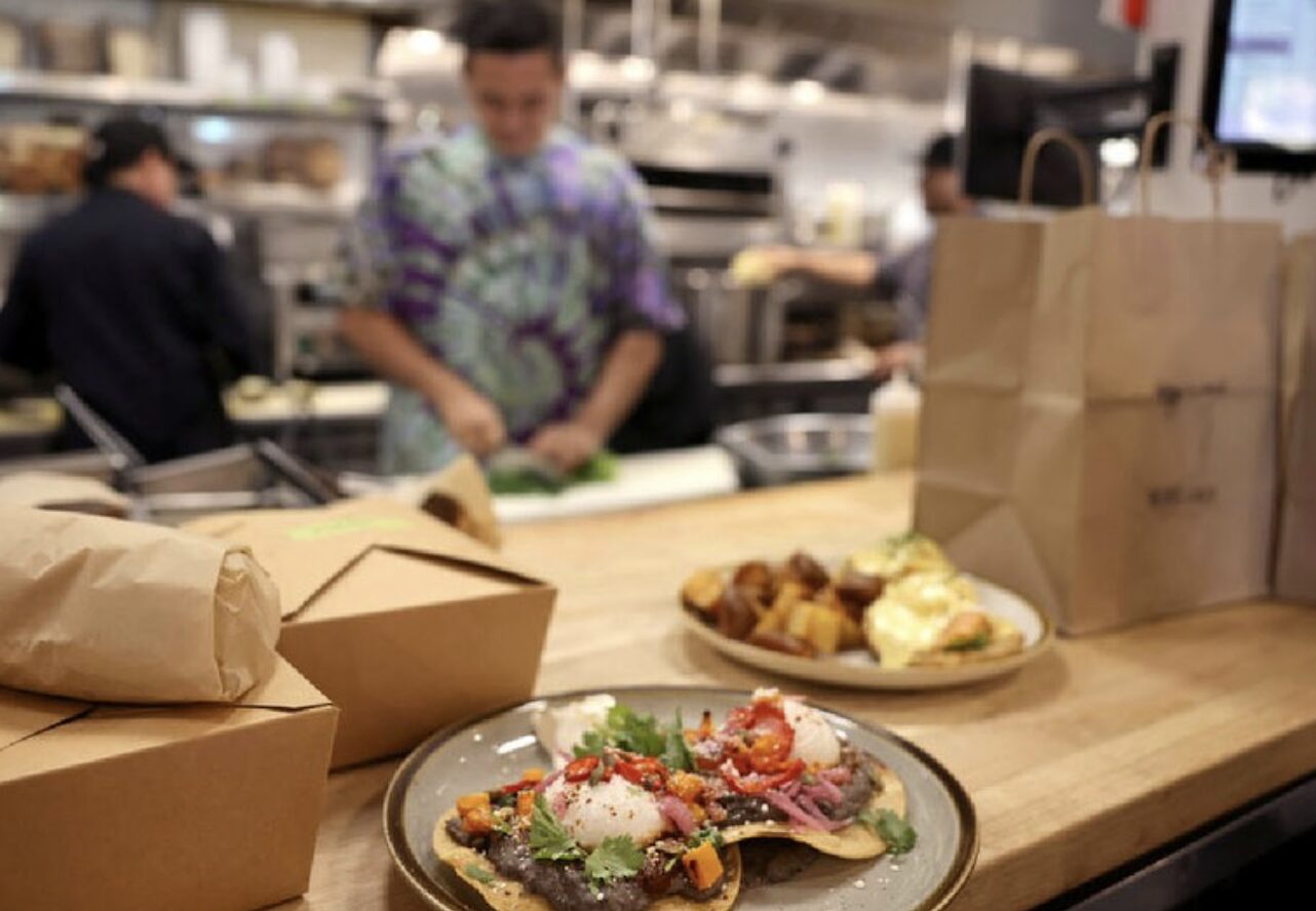 Worker prepares breakfast plates