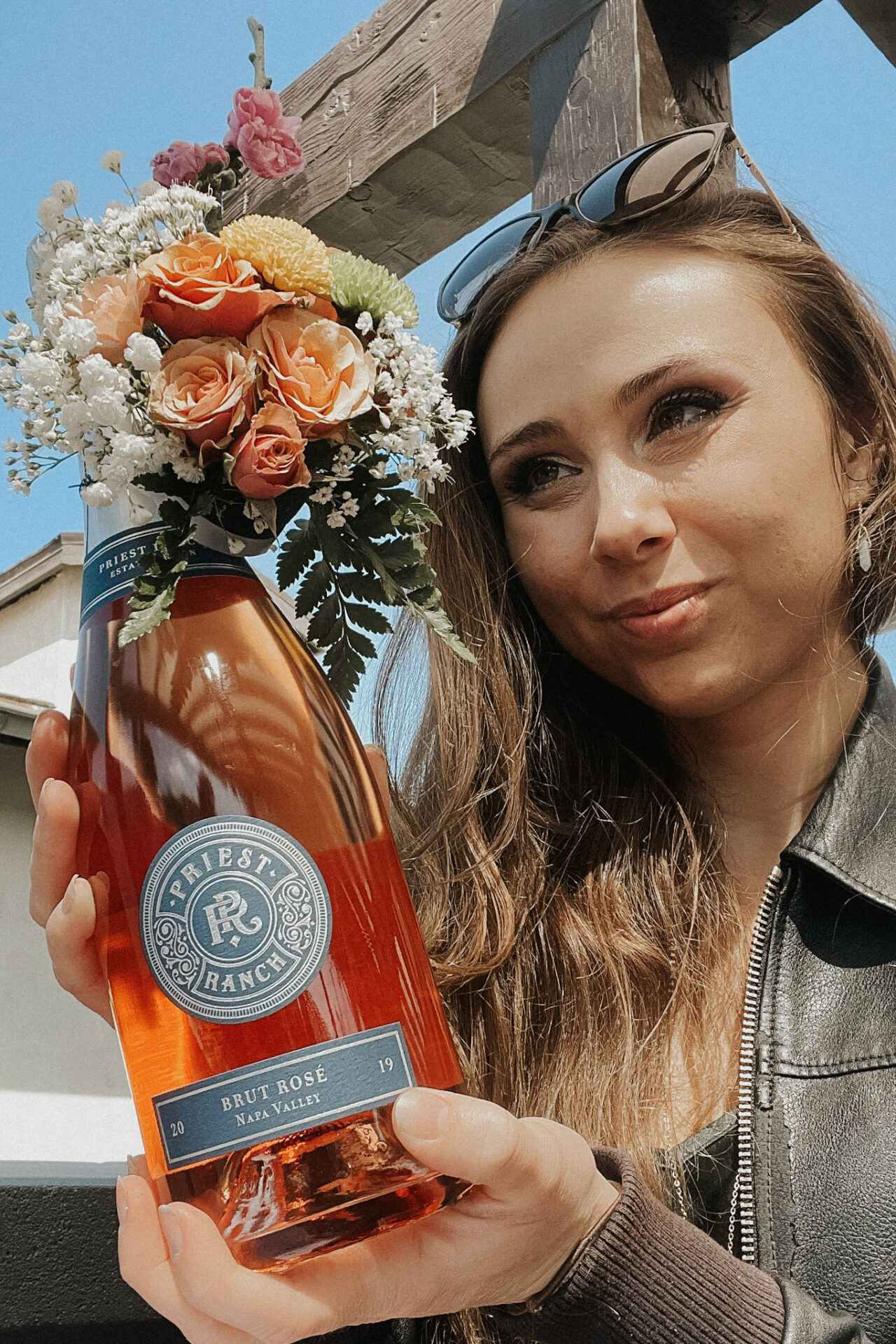 Paige holding a wine bottle bouquet