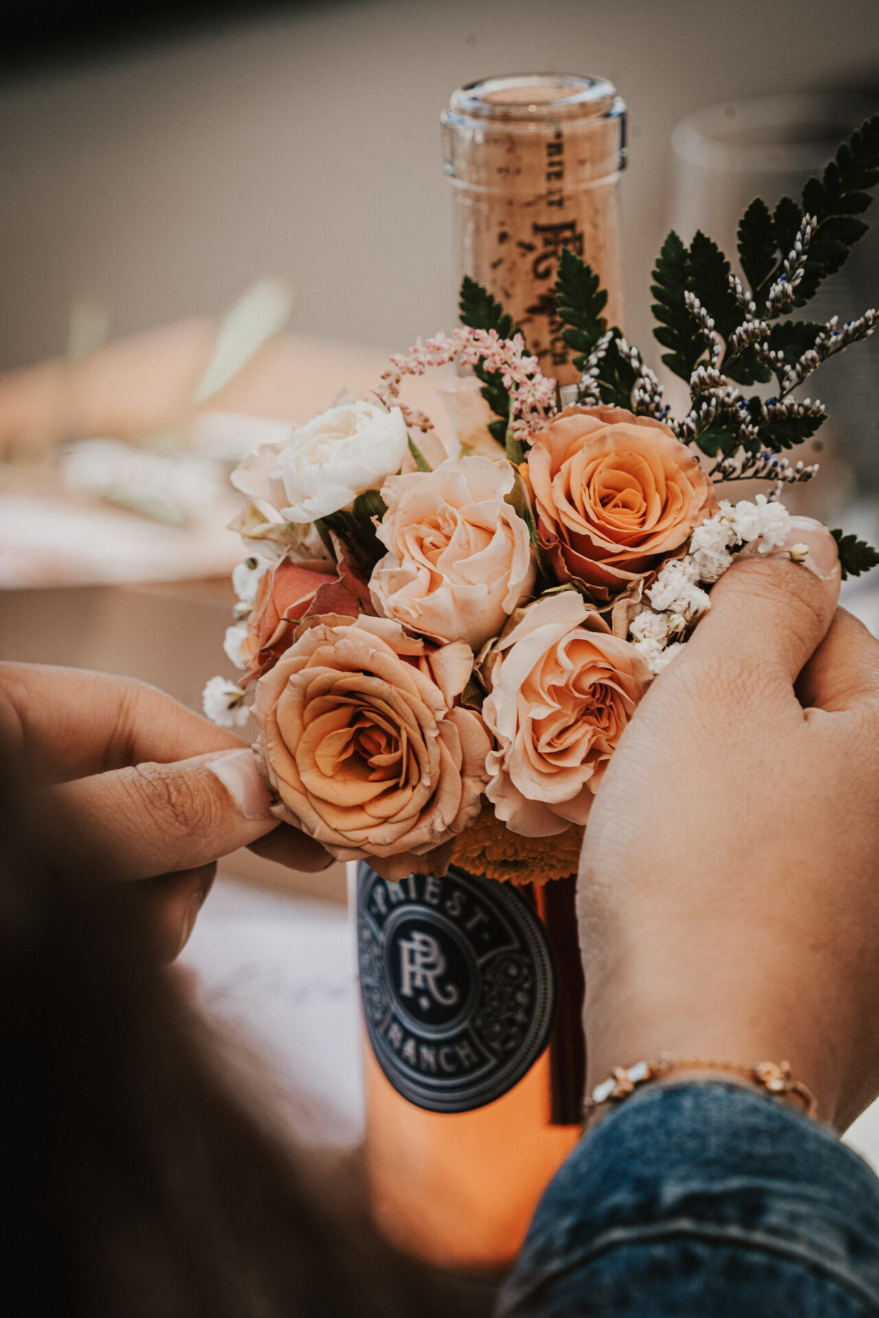 Wine Bottle Bouquet with flowers and hands