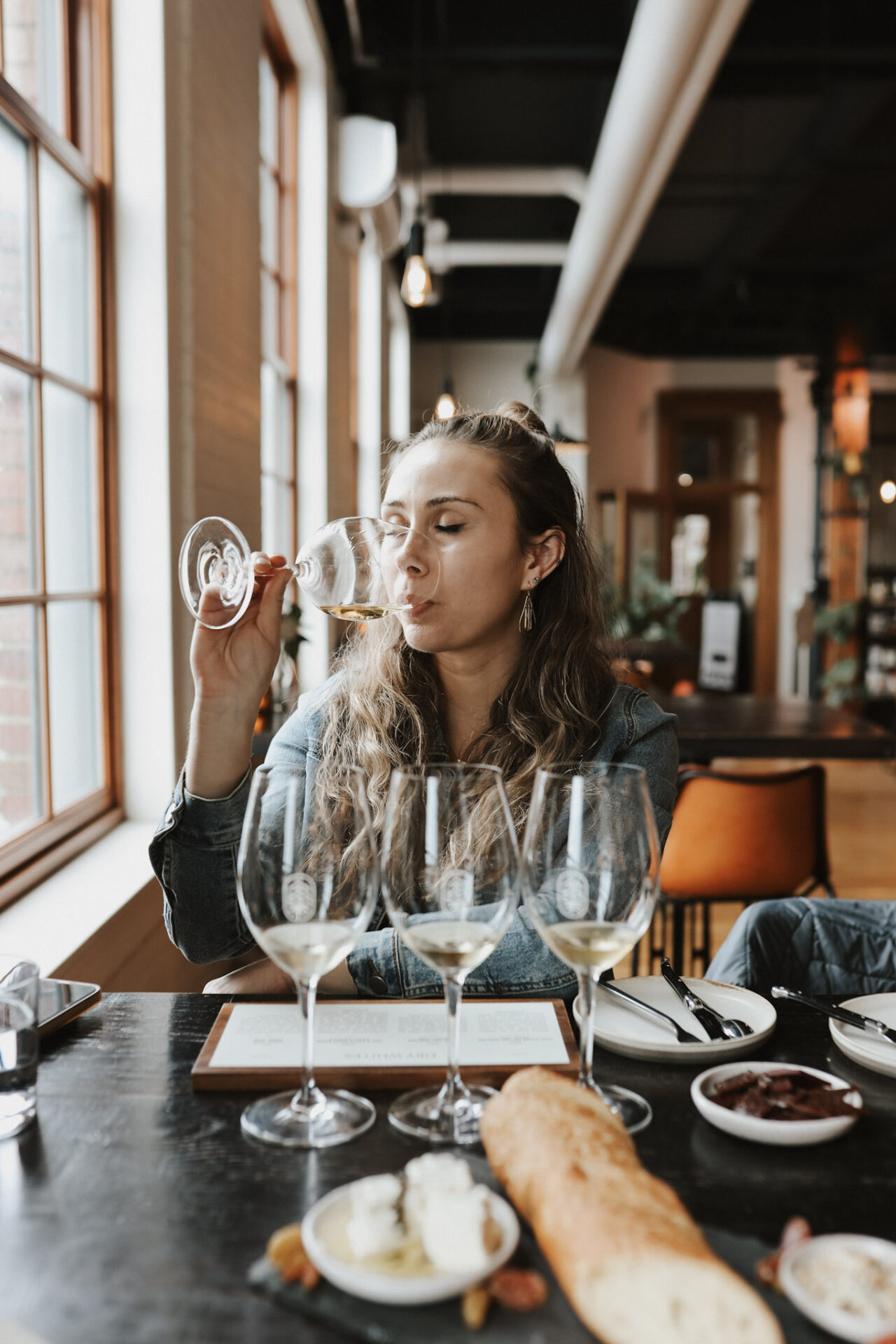 Paige sipping wine at Living Roots