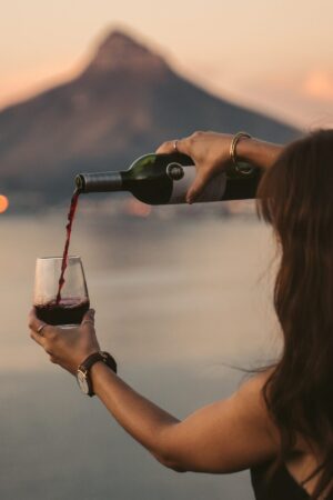 Woman pouring wine with mountain in distance