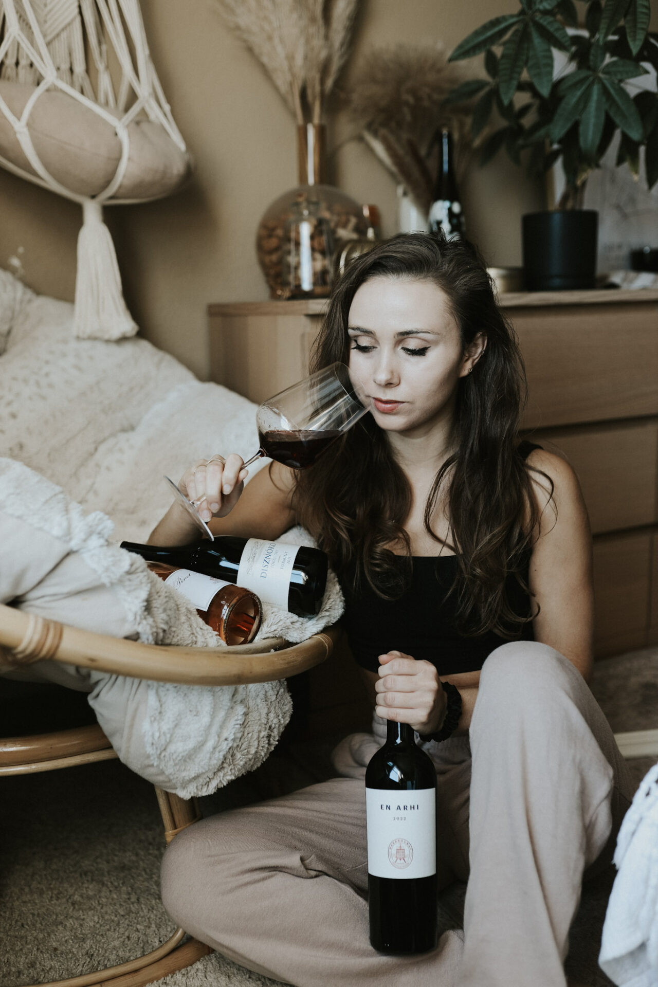 Paige enjoying wine at home, the same person behind every recommendation