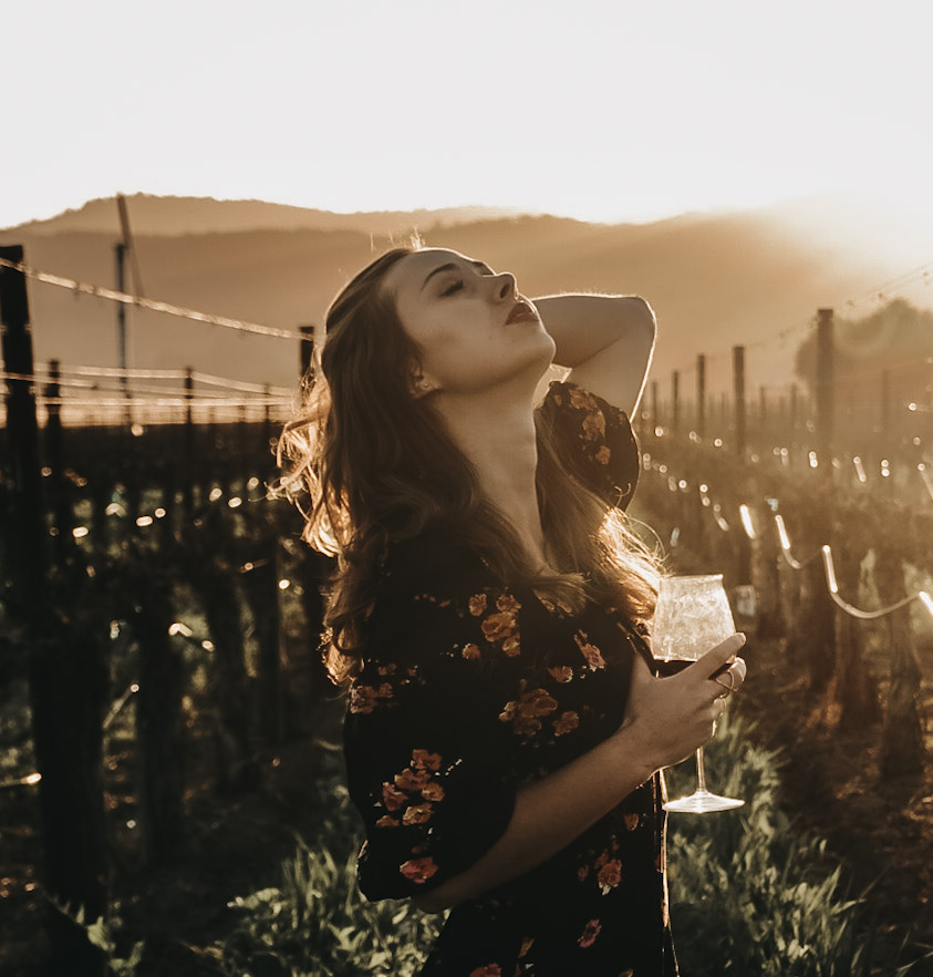 Paige Comrie in the vineyard at golden hour