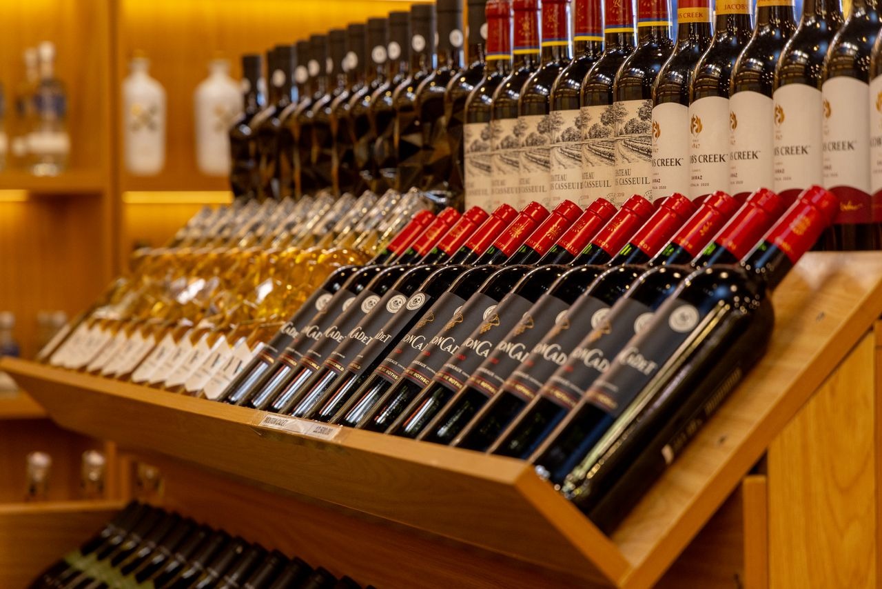 red and white wine bottles on a retail store shelf