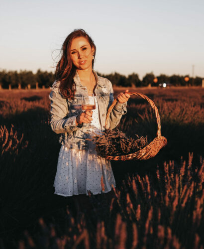 Dry January Guide - Paige holding non-alcoholic wine in a field of lavender